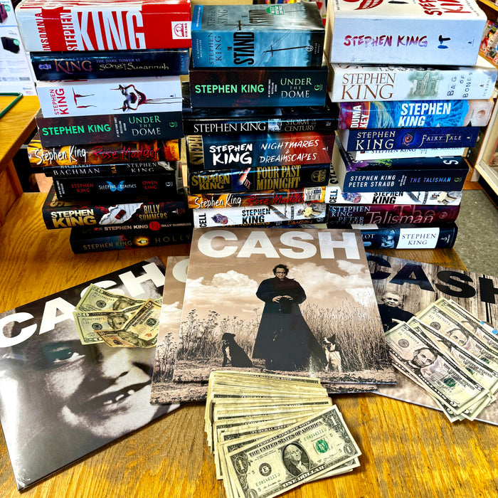 Stack of Stephen King Books with Johnny Cash Records and actual cash.